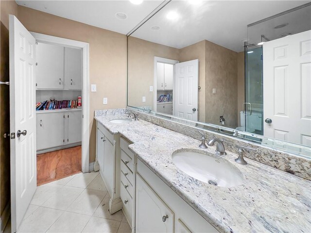 bathroom featuring tile patterned floors, vanity, and walk in shower