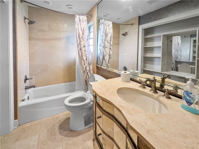 full bathroom featuring tile patterned flooring, toilet, vanity, and shower / bath combination with curtain