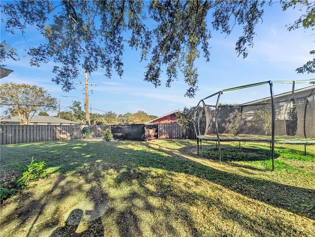 view of yard with a trampoline