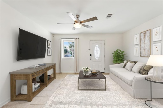 living room with ceiling fan and light tile patterned floors