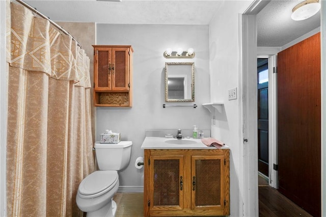 bathroom featuring vanity, a textured ceiling, toilet, and hardwood / wood-style flooring