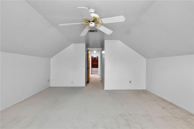 bonus room with lofted ceiling, light carpet, and ceiling fan