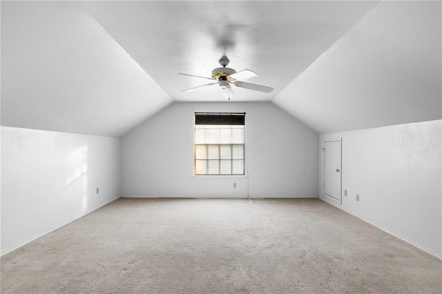 additional living space with lofted ceiling, light colored carpet, and ceiling fan