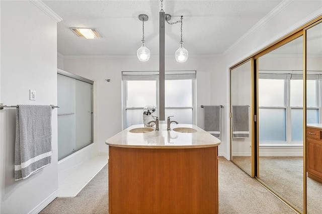 bathroom featuring vanity, a textured ceiling, combined bath / shower with glass door, and ornamental molding