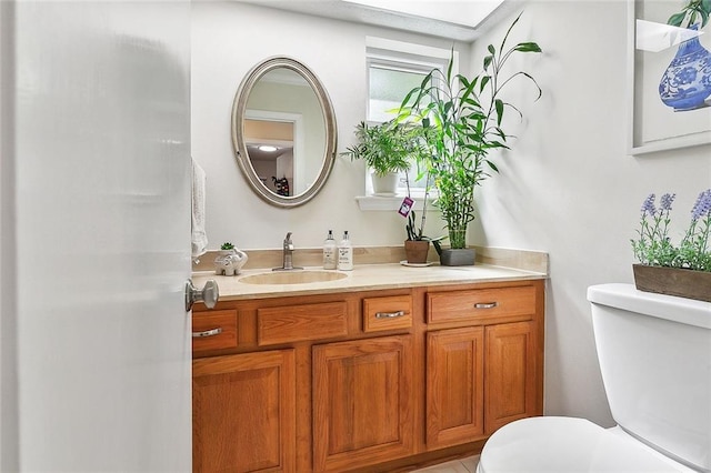 bathroom featuring toilet and vanity