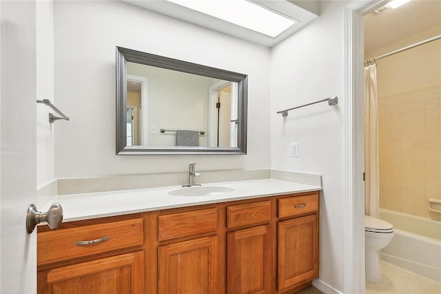 full bathroom with vanity, shower / bath combo with shower curtain, and toilet