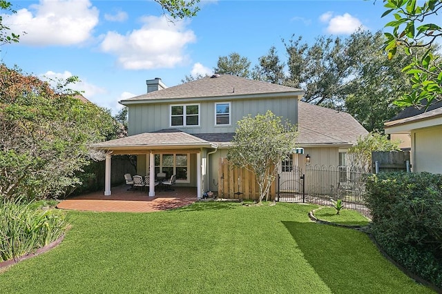 rear view of house with a patio and a yard