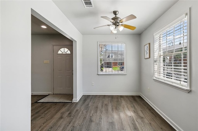 entryway featuring ceiling fan, a healthy amount of sunlight, and dark hardwood / wood-style flooring