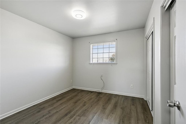 unfurnished bedroom with dark hardwood / wood-style flooring