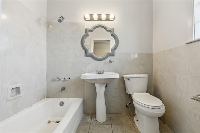 bathroom featuring toilet, sink, and tile patterned flooring