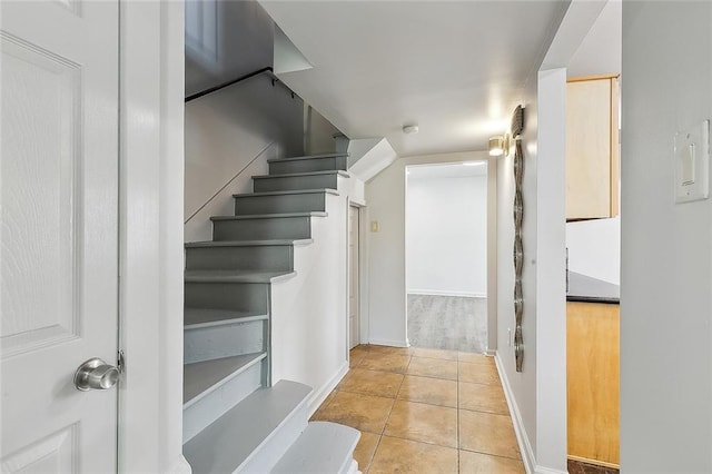 staircase featuring tile patterned floors