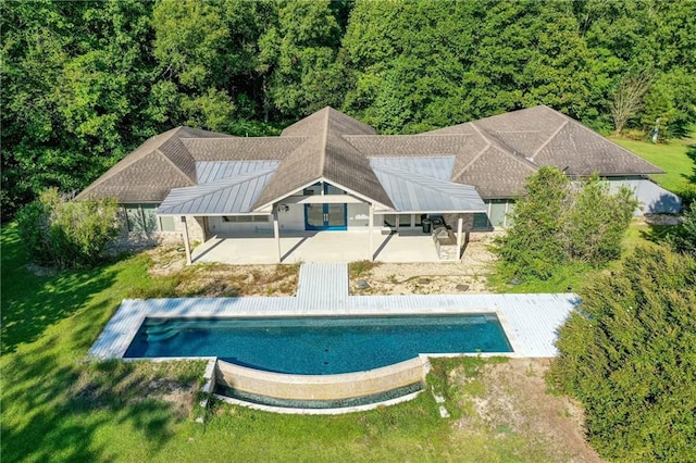 outdoor pool featuring a yard and a patio