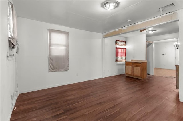 unfurnished room with dark wood-type flooring