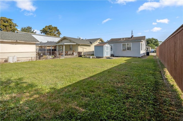 rear view of property with a storage shed and a lawn