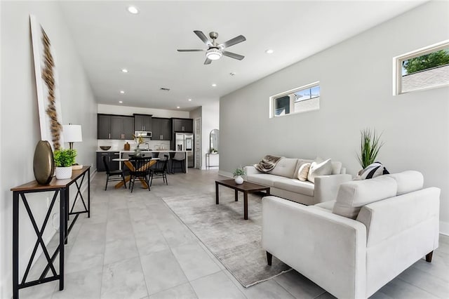 living room featuring ceiling fan and plenty of natural light