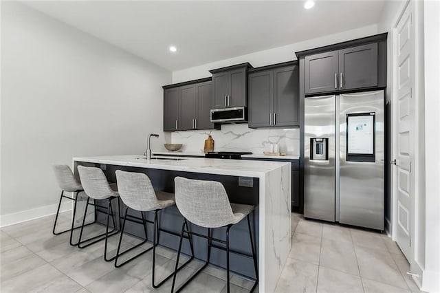 610 David St, New Orleans, LA 70119 - kitchen featuring stainless steel appliances, a sink, an island with sink, a kitchen bar, and recessed lighting