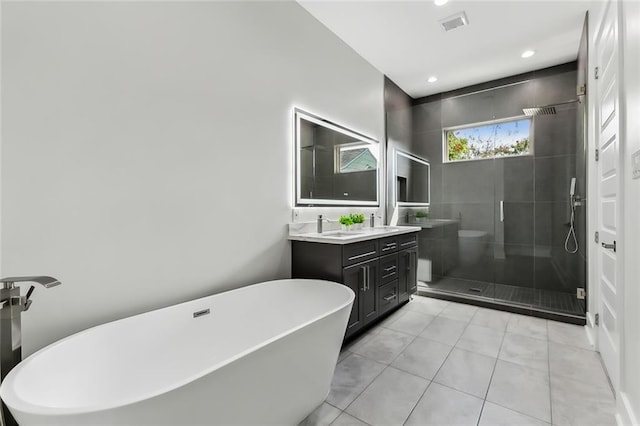 bathroom featuring vanity, shower with separate bathtub, and tile patterned flooring