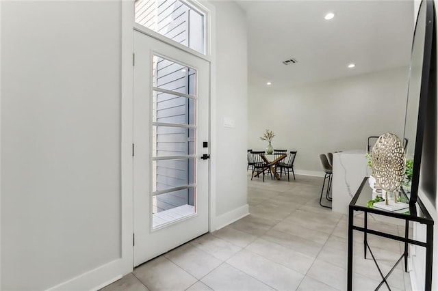 entryway with light tile patterned floors