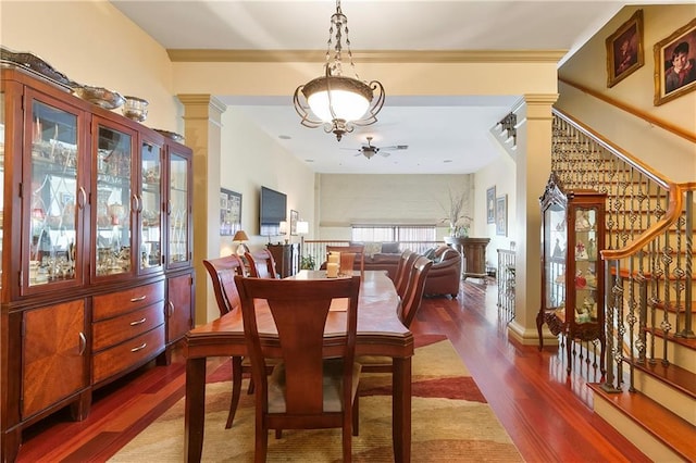 dining space with hardwood / wood-style floors, ceiling fan, and decorative columns