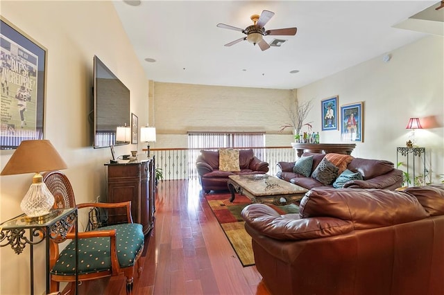 living room featuring dark hardwood / wood-style flooring and ceiling fan