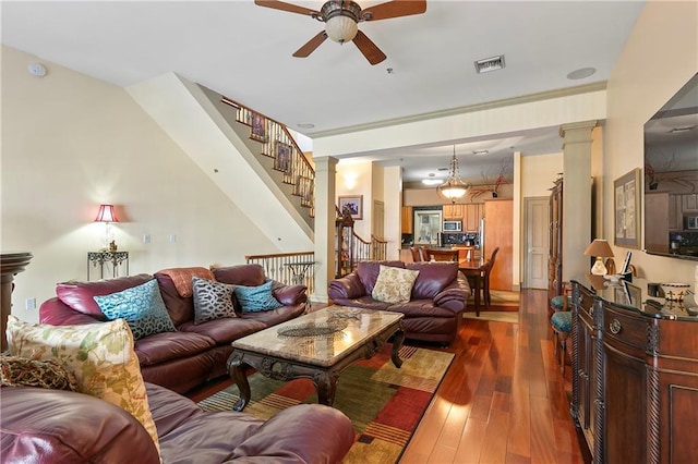 living room featuring ceiling fan and dark wood-type flooring