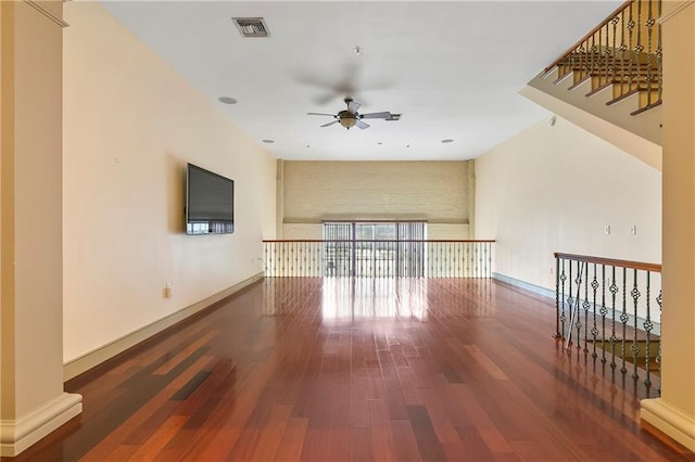 empty room featuring ceiling fan and dark wood-type flooring