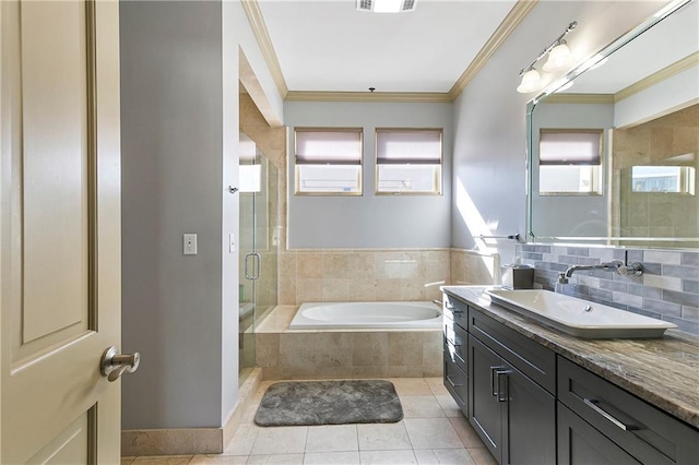 bathroom with tile patterned flooring, shower with separate bathtub, crown molding, and vanity