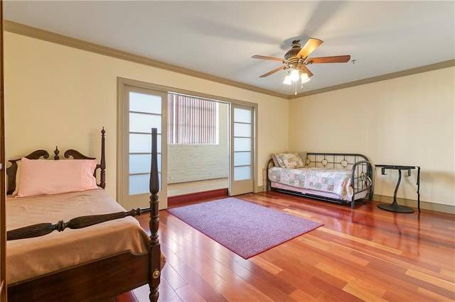 bedroom featuring ceiling fan, hardwood / wood-style flooring, and ornamental molding