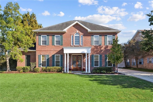 colonial-style house with a front yard