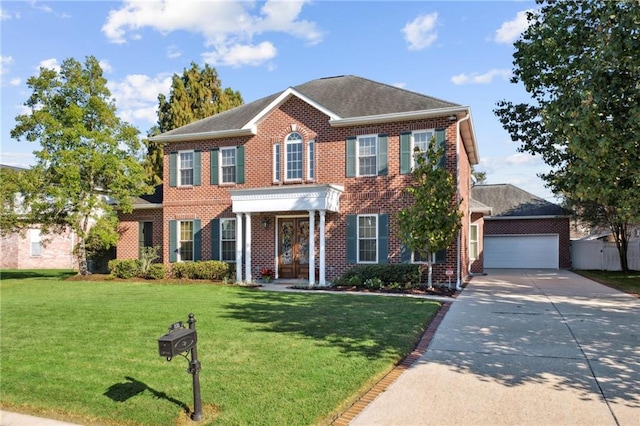 colonial-style house featuring a front lawn and a garage