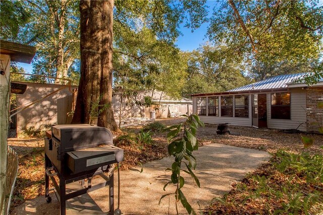 20 Silman Ave, Hammond, LA 70403 - view of patio / terrace featuring a sunroom and fence