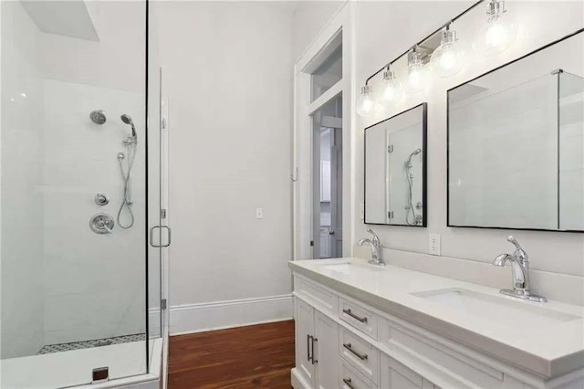 bathroom featuring vanity, hardwood / wood-style floors, and walk in shower