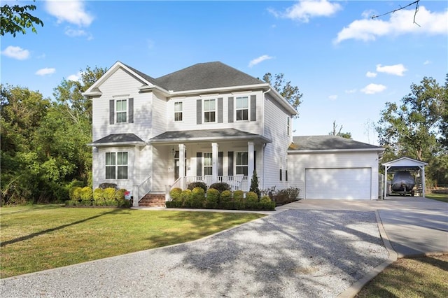 view of front facade featuring a porch, a front yard, and a garage