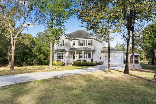 view of front of house with a front yard, a garage, and a porch