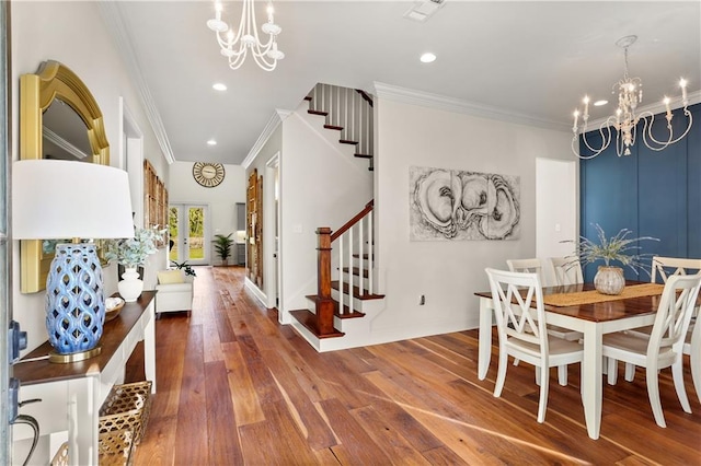 dining room featuring hardwood / wood-style flooring, ornamental molding, and a chandelier