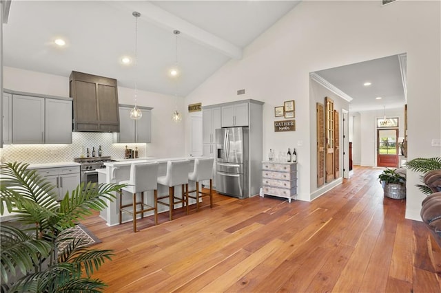 kitchen featuring appliances with stainless steel finishes, light hardwood / wood-style flooring, a kitchen breakfast bar, and gray cabinetry