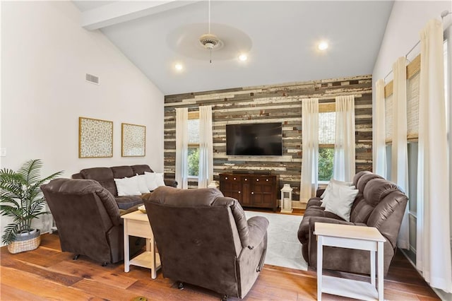 living room featuring lofted ceiling, hardwood / wood-style flooring, and ceiling fan