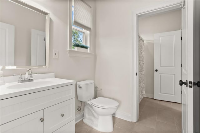 bathroom featuring vanity, toilet, and tile patterned flooring