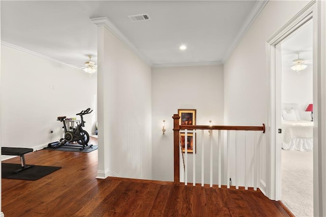 hallway featuring wood-type flooring and ornamental molding