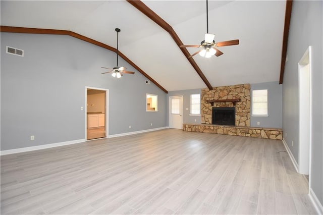 unfurnished living room featuring high vaulted ceiling, light hardwood / wood-style floors, ceiling fan, and beam ceiling