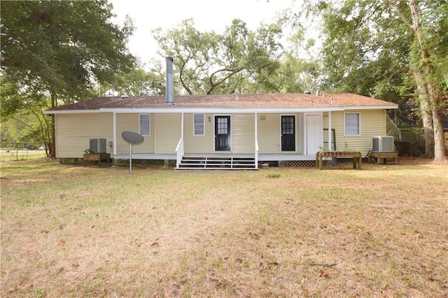 back of house featuring central AC, a lawn, and a porch