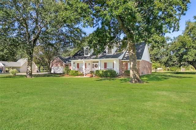 cape cod-style house with a front yard and a porch