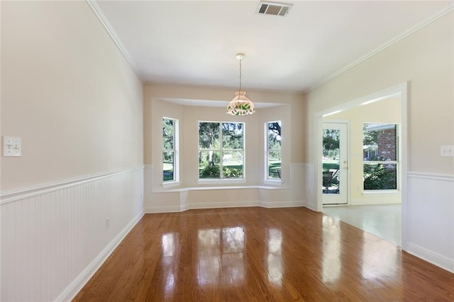 unfurnished dining area with wood-type flooring and ornamental molding