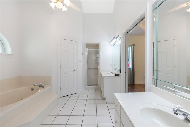 bathroom featuring tile patterned flooring, separate shower and tub, vanity, a towering ceiling, and ceiling fan