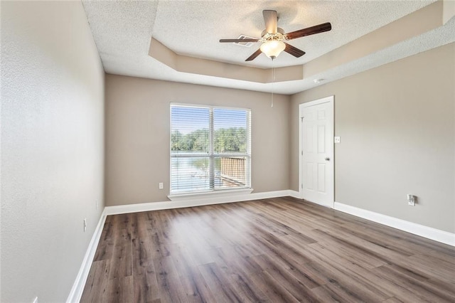 unfurnished room with a textured ceiling, wood-type flooring, and ceiling fan