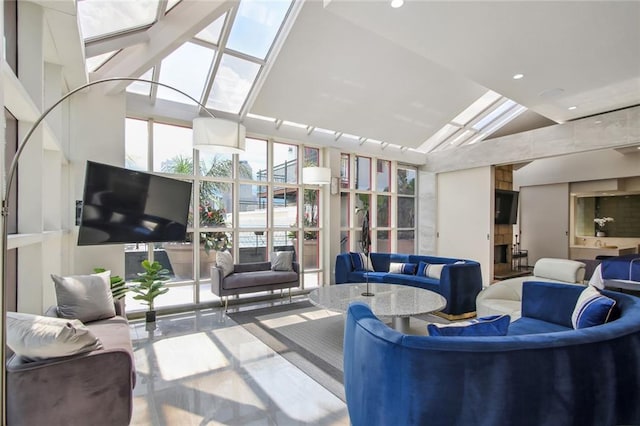 living room featuring high vaulted ceiling and a skylight