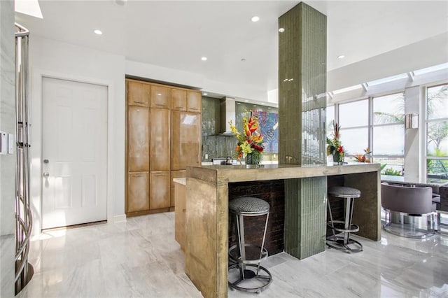 620 Decatur St Unit Phb3, New Orleans, LA 70130 - kitchen with recessed lighting, modern cabinets, a kitchen breakfast bar, marble finish floor, and a kitchen island