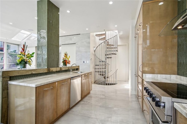 kitchen with appliances with stainless steel finishes, light stone countertops, a skylight, sink, and ventilation hood