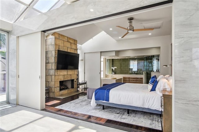 bedroom featuring ceiling fan, hardwood / wood-style flooring, and a tile fireplace