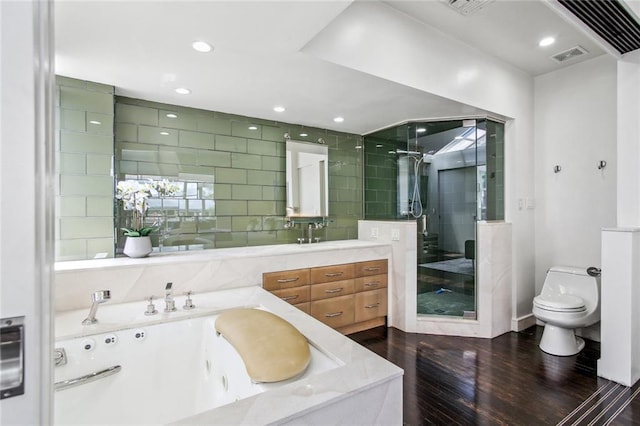 bathroom featuring vanity, a shower with shower door, wood-type flooring, and toilet